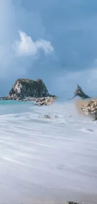 This mesmerizing phone live wallpaper showcases a magnificent body of water sitting on top of a sandy beach