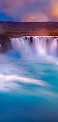 Looking for an incredible wall live wallpaper? Look no further than this breathtaking scene of a waterfall in the middle of a large body of water