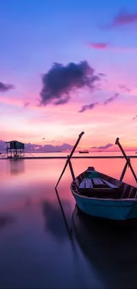 Looking for soothing live wallpapers for your phone? Look no further than this beautiful setting featuring a small boat on a body of water