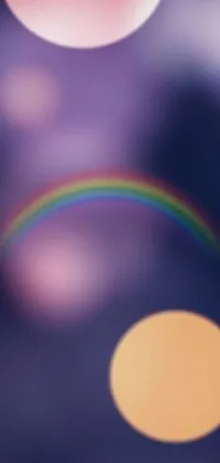 Looking for a colorful live wallpaper for your phone? Check out this stunning image featuring a beautiful rainbow in the sky, captured in a dreamy and soft focus style