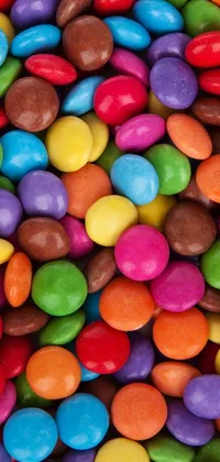 This live wallpaper is a colorful and playful image of a pile of multicolored candy sitting on a table
