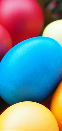 This phone live wallpaper features a delightful close-up of multicolored eggs nestled in a basket