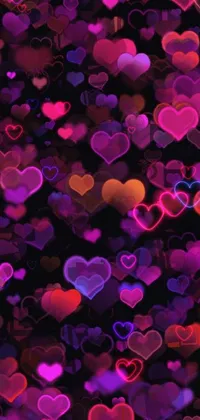 This captivating phone live wallpaper features a delightful display of pink and purple hearts dancing on a sleek black background, perfect for those who adore cute and romantic designs
