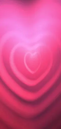 This live wallpaper boasts a striking pink heart-shaped object as the centerpiece of your phone's home screen