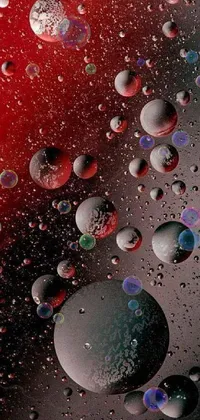 This phone live wallpaper features a red, digitally-created surface adorned with water droplets
