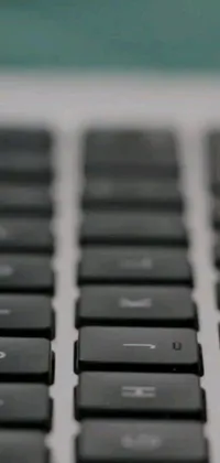 This phone live wallpaper features a detailed view of a computer keyboard with letters, numbers, and symbols that are depicted with clarity and precision