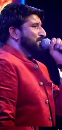 Experience the excitement of a vibrant red jacketed man singing into a microphone with this stunning live phone wallpaper