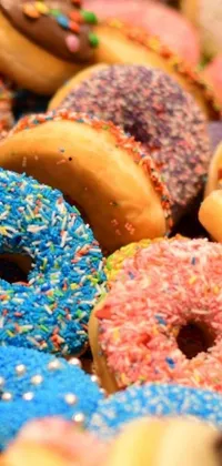 Indulge in the delicious sweetness of a phone live wallpaper that showcases a plethora of mouthwatering donuts with chocolate frosting and colorful sprinkles