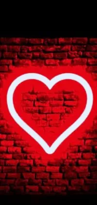 This stunning live phone wallpaper features a vibrant red heart against a textured brick wall