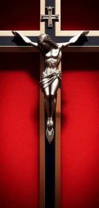 This high-resolution phone live wallpaper features an intricately detailed statue of Jesus on a polished wood cross against a vibrant red wall