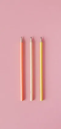 This live wallpaper features yellow, blue, and pink pencils with small erasers on a textured pale pink background