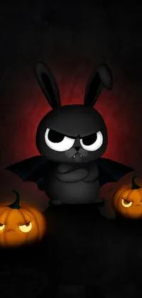 This live wallpaper features a black bunny surrounded by two grinning jack-o'-lanterns on a dark background