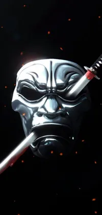 This unique phone live wallpaper features a close up of a metallic mask with a glowing sword