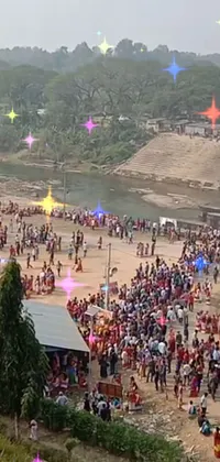This phone live wallpaper depicts a happening scene of people dressed in traditional Bihu dress, mekhela sador, standing on a sandy beach, surrounded by a river with sparkling lights