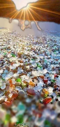 This captivating live wallpaper showcases a serene beach landscape with sea glass scattered on the sand