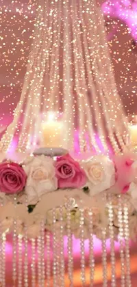 This cozy phone live wallpaper features a gorgeous chandelier filled with candles and flowers