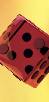 This phone live wallpaper features a high-resolution close up image of a single dice against a bold yellow background