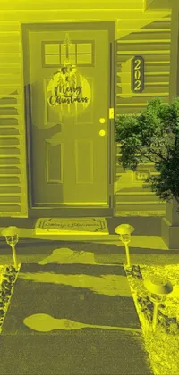 This yellow house live wallpaper features an eerie and festive ambiance with Halloween decorations