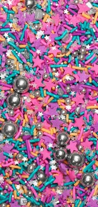 This phone live wallpaper features a vibrant pile of sprinkles inspired by colorful designs and patterns