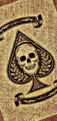 This mobile live wallpaper is a gothic art rendition of a playing card featuring a skull on a faded parchment background