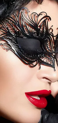 Set your phone apart with this stunning live wallpaper featuring an up-close view of a black mask with intricate art nouveau designs
