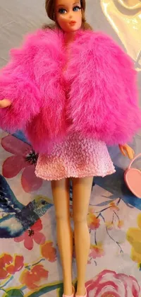 This stunning live wallpaper features a fashionable Barbie doll, wearing a fluffy pink fur coat and holding a pink purse