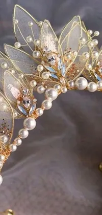 This stunning live phone wallpaper depicts a tiara adorned with pearls and opal petals set against a baroque-inspired background