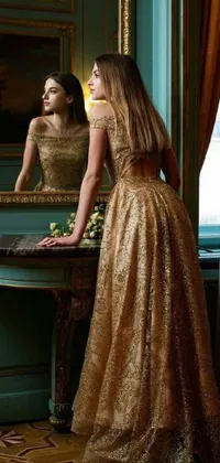 This phone live wallpaper showcases an elegant woman in a royal golden color scheme, standing in front of a mirror in a beautiful dress