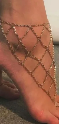 Adorn your phone with a stunning live wallpaper featuring a polished bronze chain ankle bracelet on a tanned foot, evoking a goddess-like feeling