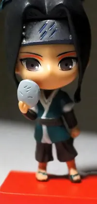 This mobile live wallpaper showcases a lovely figurine of a woman grasping a ball