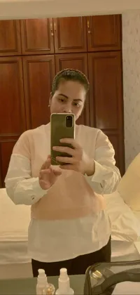 This captivating live wallpaper captures a playful moment of a woman taking a selfie in front of a mirror