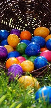 Looking to add a pop of color to your phone display? Look no further than this vibrant Easter themed live wallpaper! The open basket overflows with multicolored, tie-dye inspired Easter eggs set against a bright, sunny background