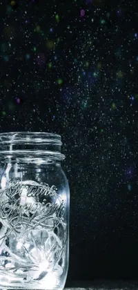 This phone live wallpaper features a stunning jar filled with sparkling lights on a table