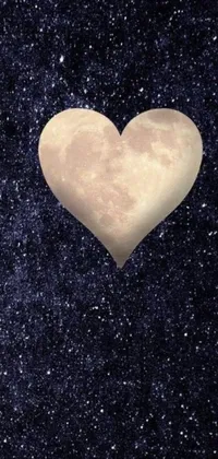 Decorate your phone screen with this stunning live wallpaper featuring a heart-shaped object in a beautiful night sky