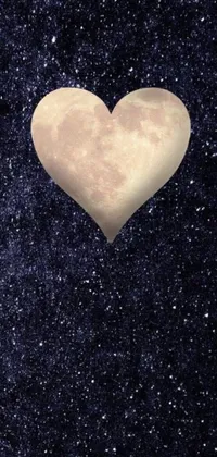 This phone live wallpaper depicts a beautiful heart-shaped object floating in the midst of a starry night sky