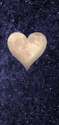 This live wallpaper depicts a heart-shaped object against a beautiful night sky filled with stars