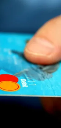 This phone live wallpaper showcases a digital rendering of a credit card held in a close-up view