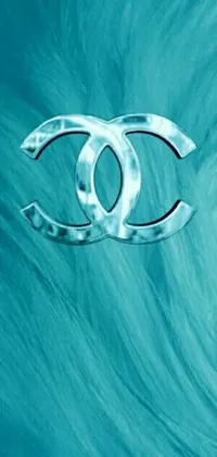 Enhance your phone's look with this vibrant blue live wallpaper showcasing an iconic Chanel logo at its center