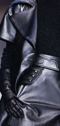 This live phone wallpaper features a mysterious monochrome runway model wearing black gloves and donning leather armor