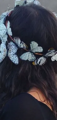 This live phone wallpaper features a portrait of a woman donning a floral crown surrounded by swallowtail butterflies in a vintage-inspired Tumblr aesthetic