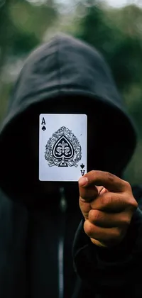 This live wallpaper depicts a hooded wraith holding an ace card in front of the face