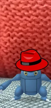 This phone live wallpaper features a fun and playful cartoon character wearing a red hat and blue fedora