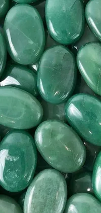 This phone live wallpaper displays a close-up view of green stones