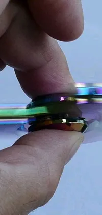 This stunning phone live wallpaper features an up-close view of a spinning, holographic blade with a thickness of 3mm, radiating vibrant colors in 2