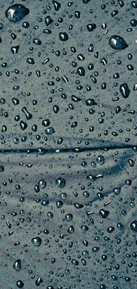This live wallpaper features a realistic painting of a blue umbrella adorned with water droplets