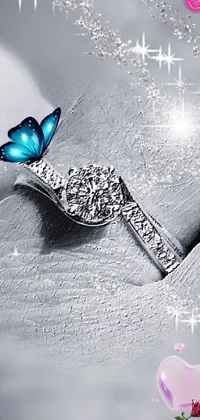 Looking for a stunning and elegant phone live wallpaper? Check out this beautiful blue butterfly resting on top of a delicate piece of jewelry