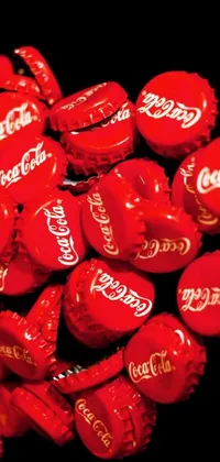 This live wallpaper features an artistic depiction of a colorful pile of Coca Cola cans, set against a striking backdrop
