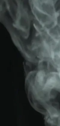 Enjoy this unique live wallpaper for your phone featuring the mesmerizing movement of smoke on a black background