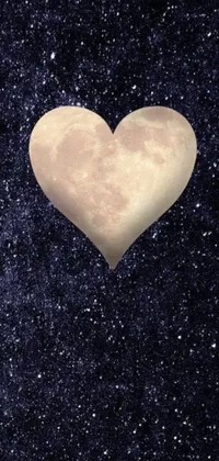 This phone live wallpaper depicts a heart-shaped object suspended in a dark, starry night sky