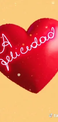 This live wallpaper is a stunning display of a vibrant red heart with the word "Barbie" written on it in bold white lettering